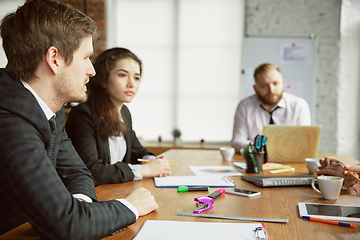 Image showing Group of young business professionals having a meeting, creative office