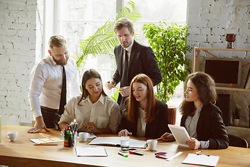 Image showing Group of young business professionals having a meeting, creative office