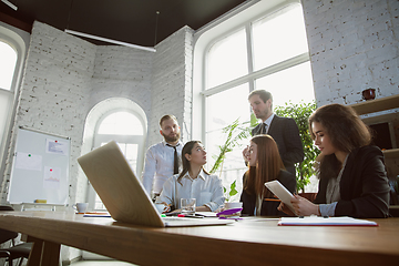 Image showing Group of young business professionals having a meeting, creative office