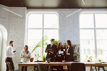 Image showing Group of young business professionals having a meeting, creative office