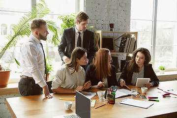 Image showing Group of young business professionals having a meeting, creative office