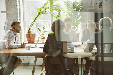 Image showing Group of young business professionals having a meeting, creative office