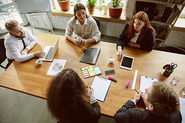 Image showing Group of young business professionals having a meeting, creative office