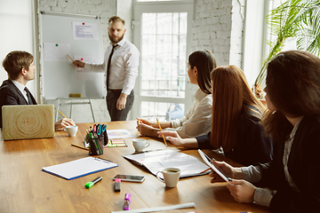 Image showing Group of young business professionals having a meeting, creative office