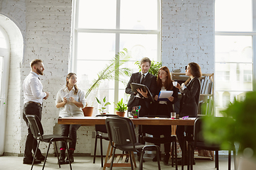 Image showing Group of young business professionals having a meeting, creative office