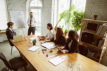 Image showing Group of young business professionals having a meeting, creative office