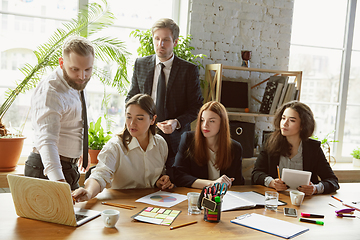 Image showing Group of young business professionals having a meeting, creative office