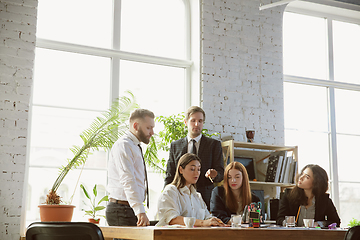 Image showing Group of young business professionals having a meeting, creative office