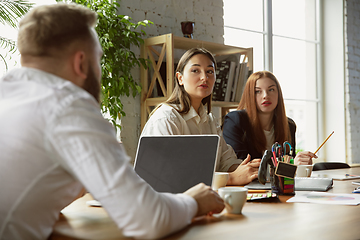 Image showing Group of young business professionals having a meeting, creative office