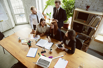 Image showing Group of young business professionals having a meeting, creative office