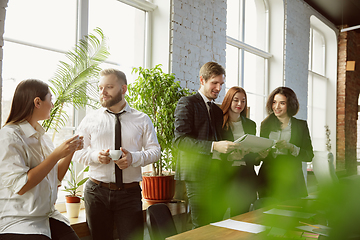 Image showing Group of young business professionals having a meeting, creative office