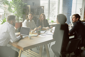 Image showing Group of young business professionals having a meeting, creative office