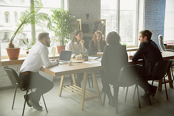 Image showing Group of young business professionals having a meeting, creative office