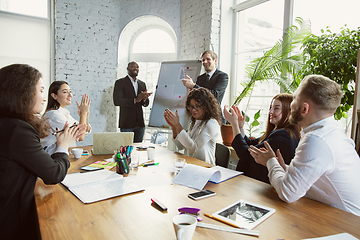 Image showing Group of young business professionals having a meeting, creative office