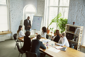 Image showing Group of young business professionals having a meeting, creative office