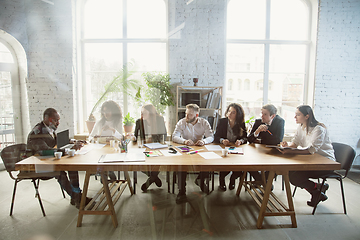 Image showing Group of young business professionals having a meeting, creative office