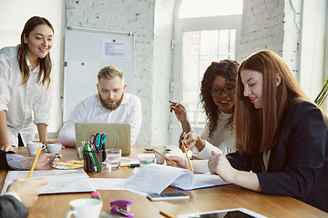 Image showing Group of young business professionals having a meeting, creative office