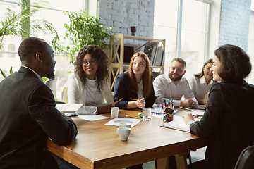 Image showing Group of young business professionals having a meeting, creative office