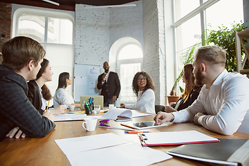 Image showing Group of young business professionals having a meeting, creative office