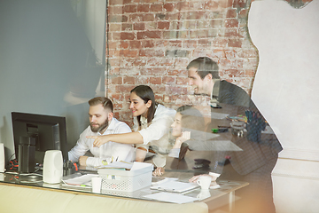 Image showing Group of young business professionals having a meeting, creative office