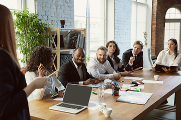 Image showing Group of young business professionals having a meeting, creative office