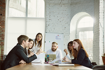 Image showing Group of young business professionals having a meeting, creative office