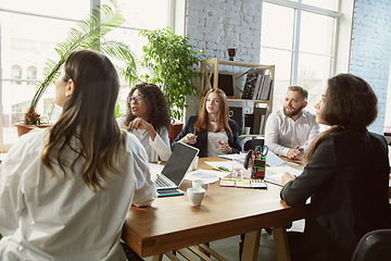 Image showing Group of young business professionals having a meeting, creative office