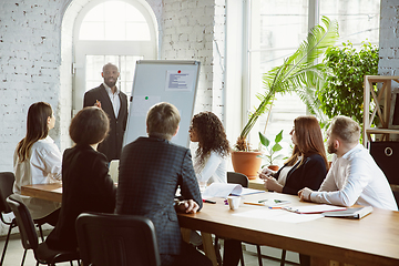 Image showing Group of young business professionals having a meeting, creative office