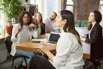 Image showing Group of young business professionals having a meeting, creative office