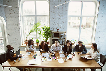 Image showing Group of young business professionals having a meeting, creative office