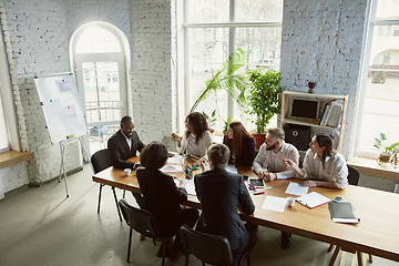 Image showing Group of young business professionals having a meeting, creative office