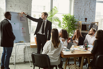 Image showing Group of young business professionals having a meeting, creative office