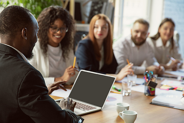 Image showing Group of young business professionals having a meeting, creative office