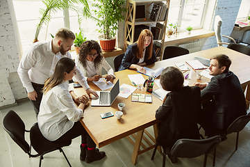 Image showing Group of young business professionals having a meeting, creative office