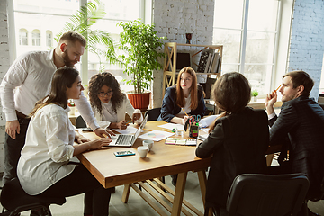 Image showing Group of young business professionals having a meeting, creative office