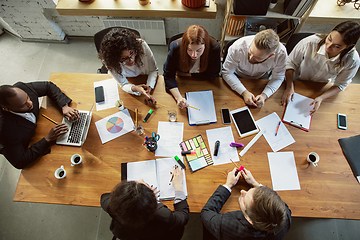 Image showing Group of young business professionals having a meeting, creative office