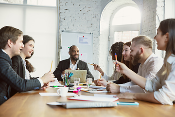 Image showing Group of young business professionals having a meeting, creative office