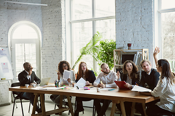 Image showing Group of young business professionals having a meeting, creative office