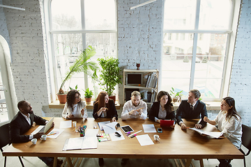 Image showing Group of young business professionals having a meeting, creative office