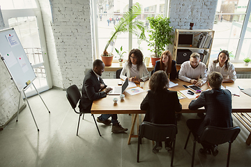 Image showing Group of young business professionals having a meeting, creative office