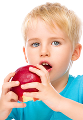 Image showing Portrait of a cute little boy with red apple