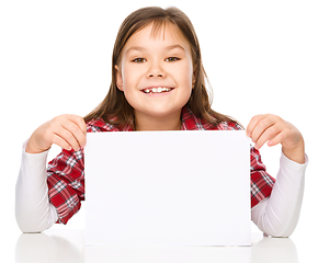 Image showing Little girl is looking from out blank board