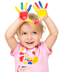 Image showing Portrait of a cute little girl playing with paints