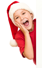 Image showing Little girl is holding her face in astonishment