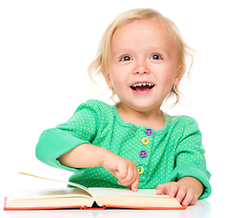 Image showing Little girl is reading her book