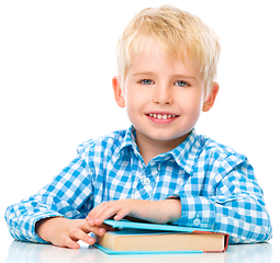 Image showing Little child play with book