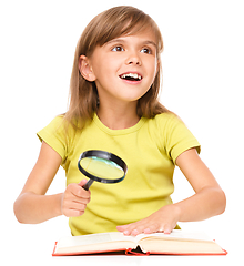 Image showing Little girl is reading book