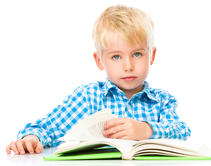 Image showing Little child play with book