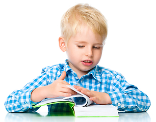 Image showing Little child play with book