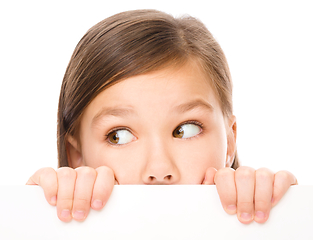 Image showing Little girl is looking from out blank board